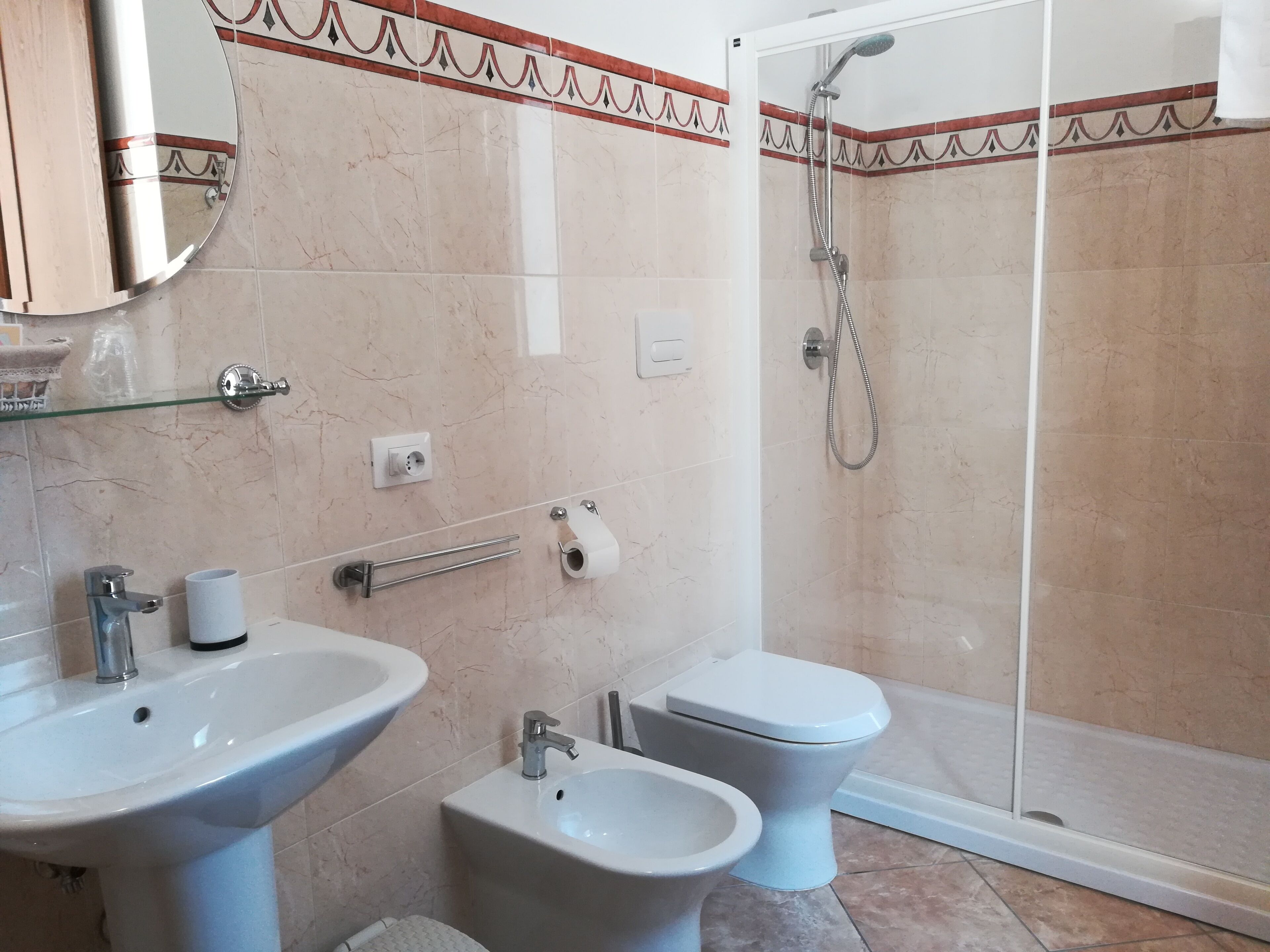 A bathroom with two sinks, a toilet, and a shower.