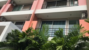 A multi-story building with balconies and air conditioning units.