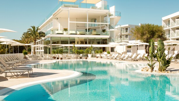 A modern hotel with a large swimming pool, sun loungers, and outdoor seating areas. - Monsuau Cala D'Or Hotel - Adults Only (Felanitx)