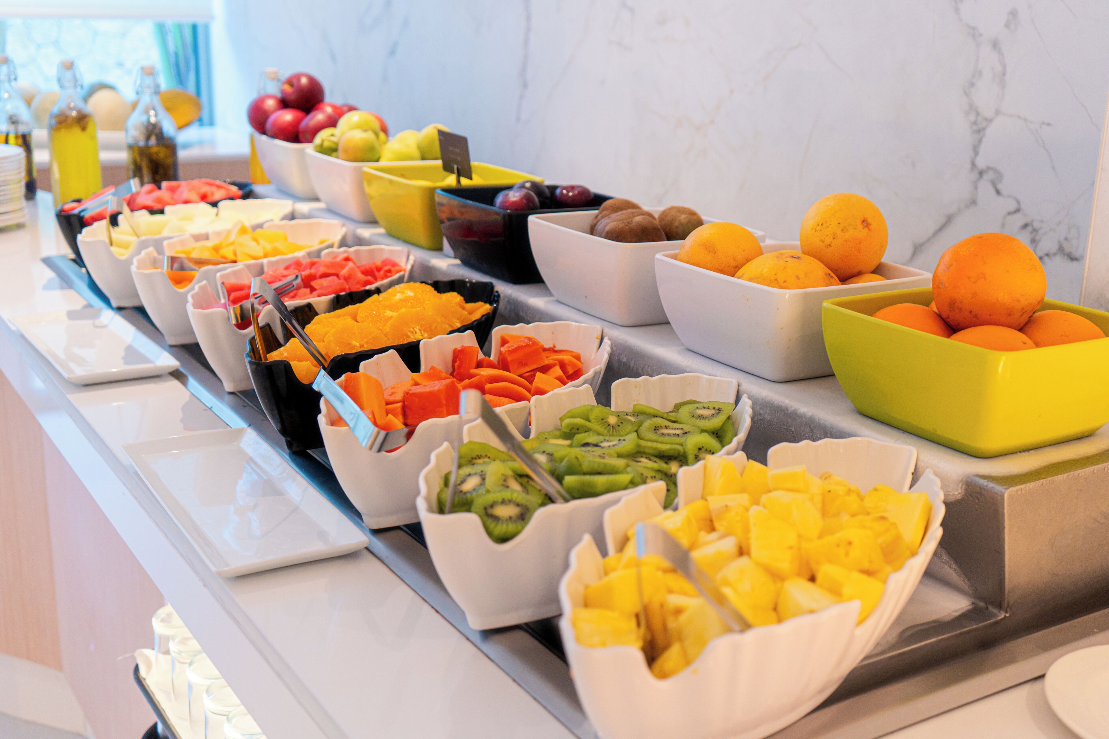 A buffet with various fruits and vegetables.