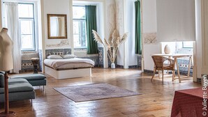 A room with a bed, a chair, a table, and a window with curtains. - Azulejos Cais Sodré B&B (Lisbon)
