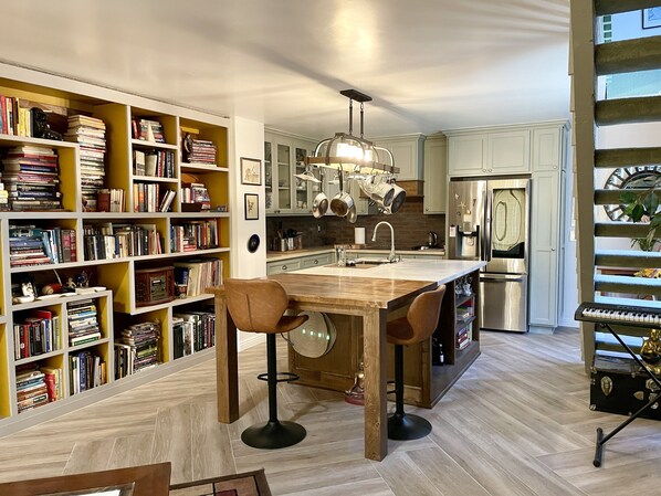 Kitchen Island has a built in dining butcher block table.