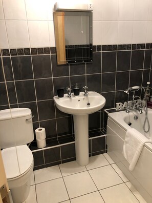 Bathtub, hair dryer, towels, soap