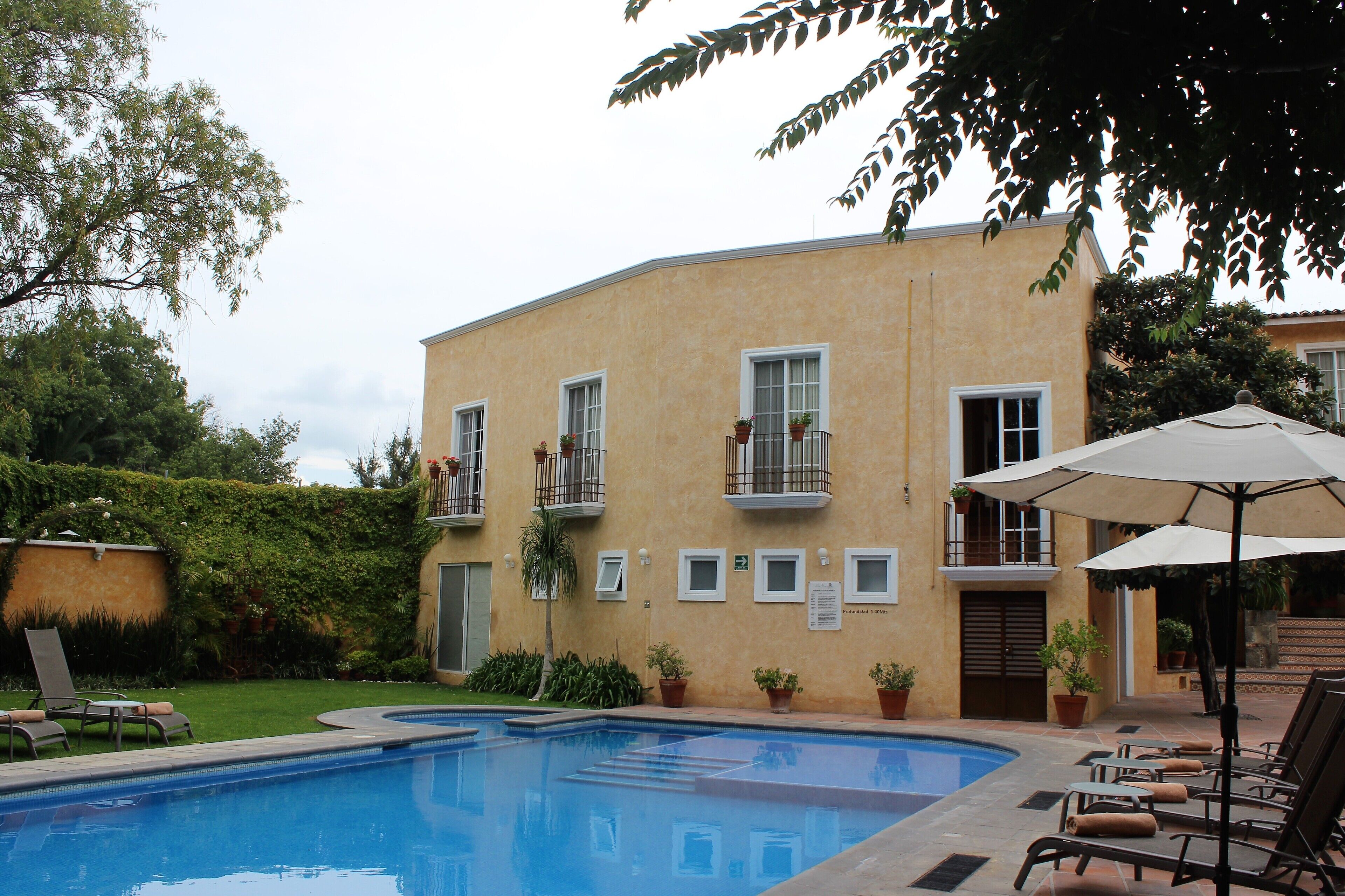 outdoor pool, open 9:00 am to 8:00 pm, pool umbrellas, pool loungers