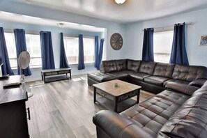 A living room with a leather sofa, a coffee table, and a bench.