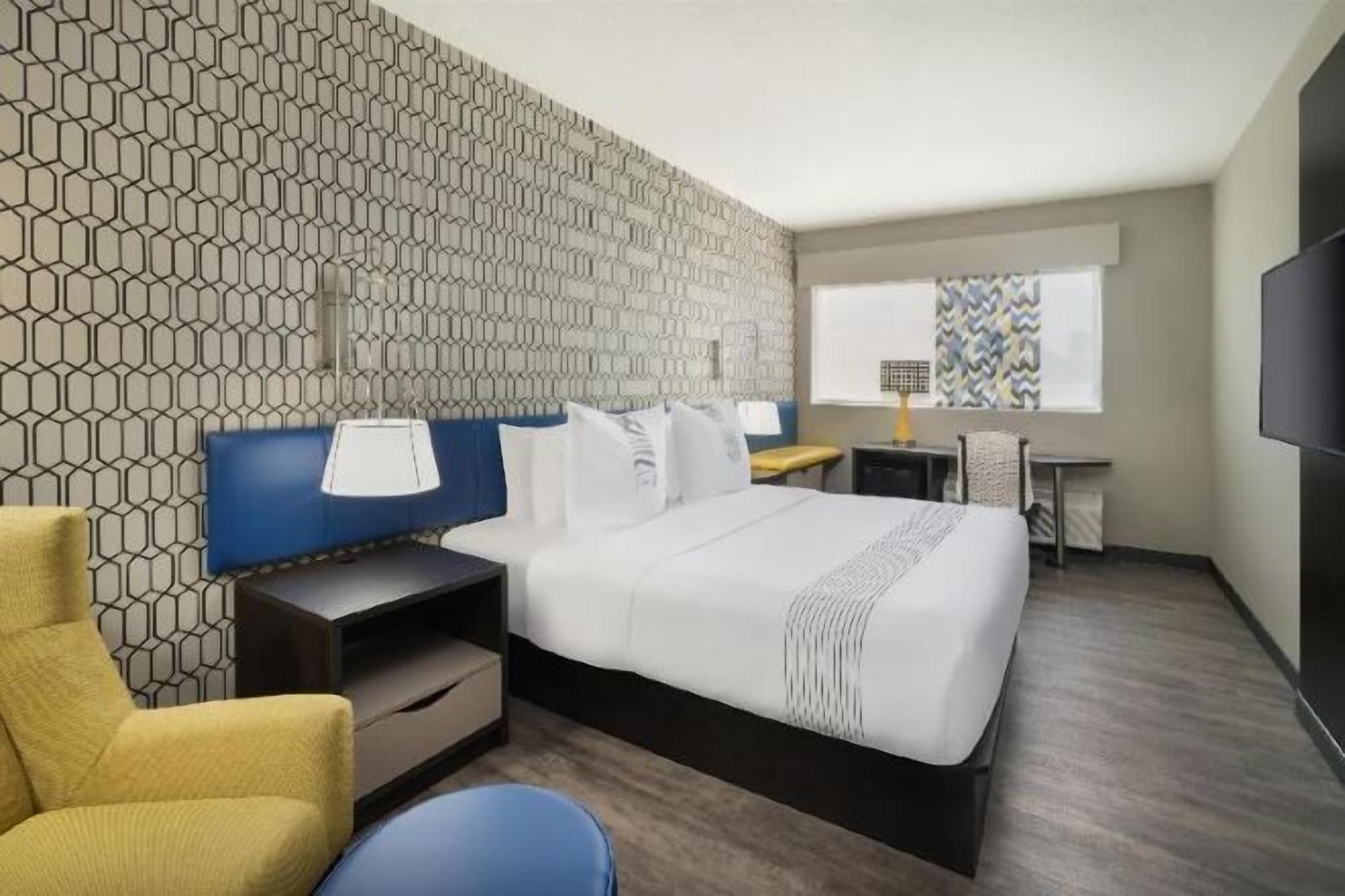 Premium bedding, memory-foam beds, laptop workspace, blackout curtains