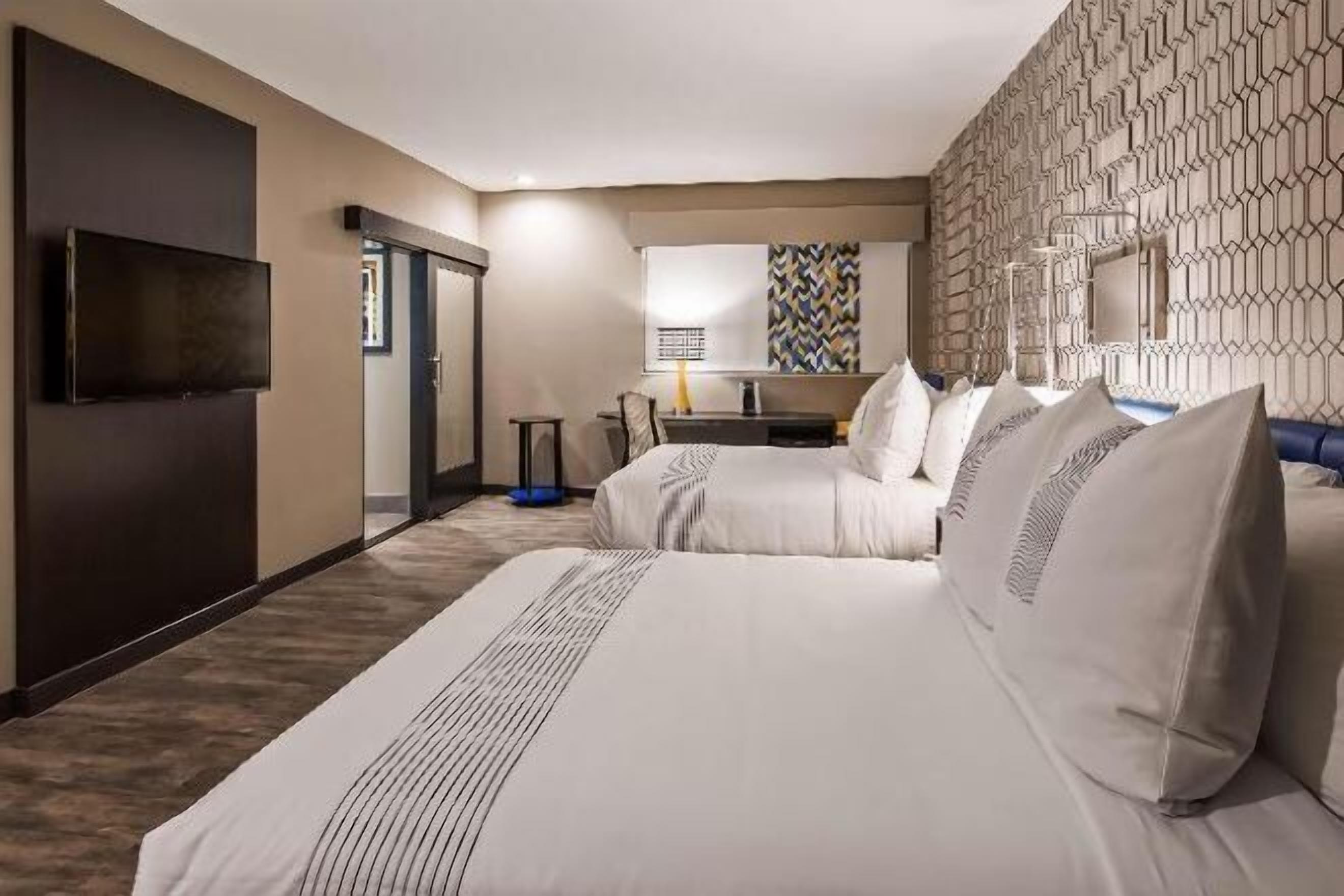 Premium bedding, memory-foam beds, laptop workspace, blackout curtains