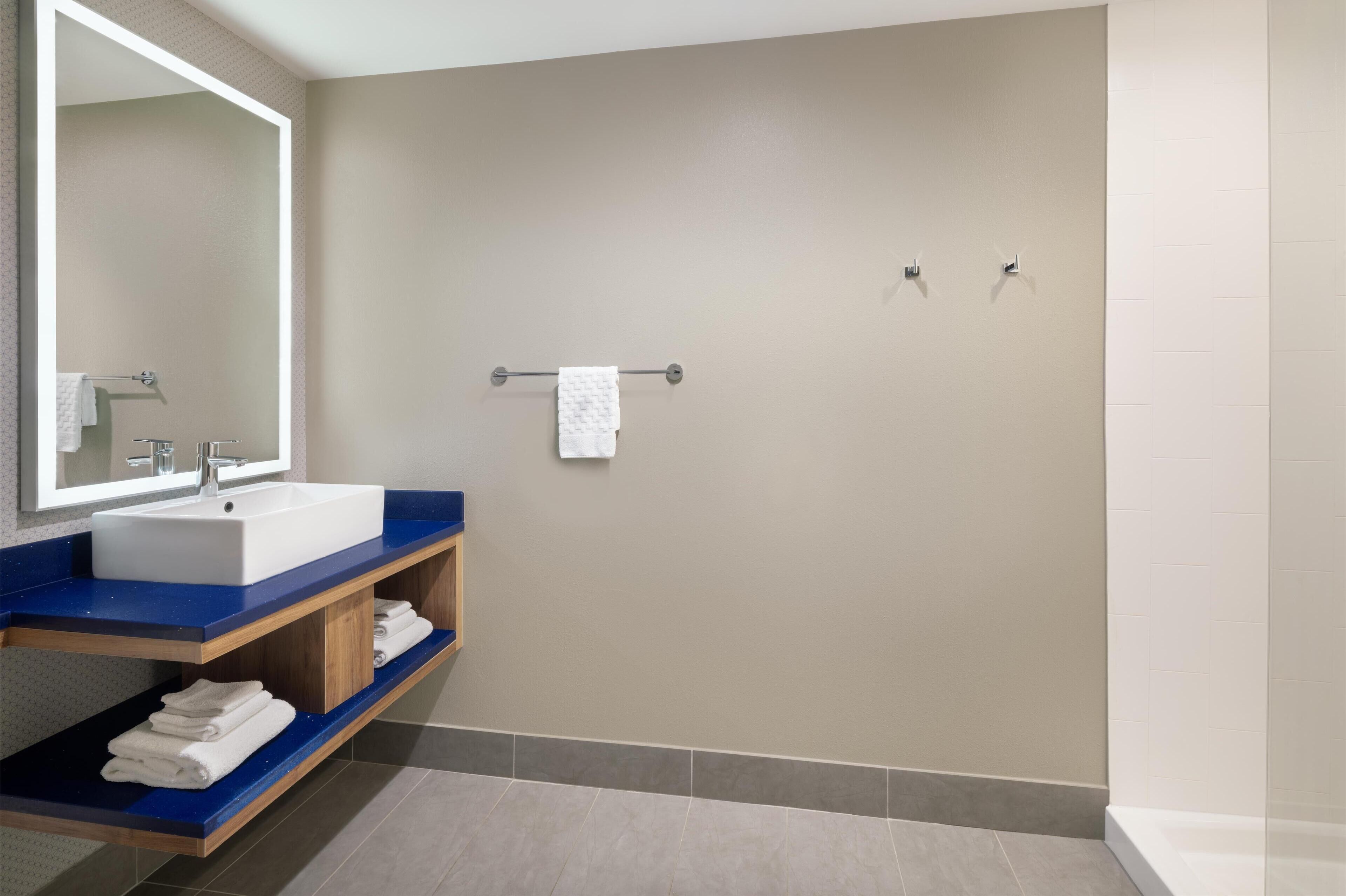 designer toiletries, hair dryer, towels, soap