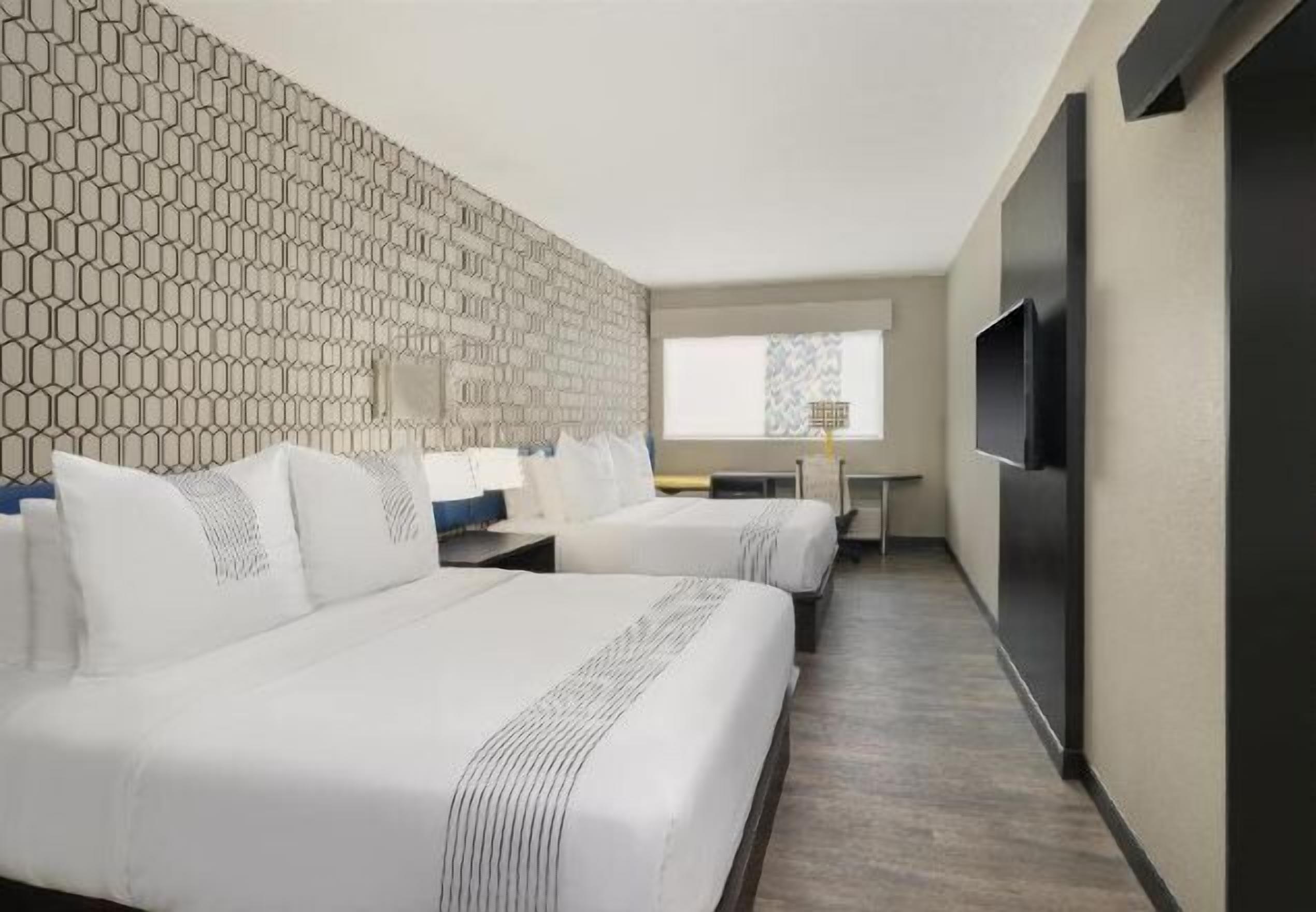 Premium bedding, memory-foam beds, laptop workspace, blackout curtains