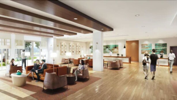 A modern hotel lobby with seating areas, a reception desk, and artwork on the walls. - Estrella at Casino Del Sol (Tucson)