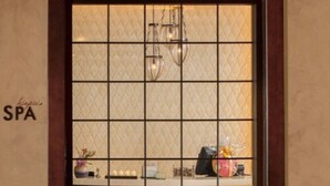 A spa with a tiled wall and a window displaying various items. - Estrella at Casino Del Sol (Tucson)