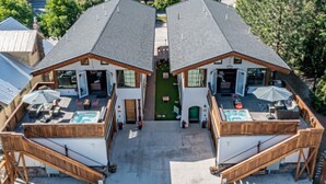 A two-story building with a central courtyard, outdoor seating, and a swimming pool.