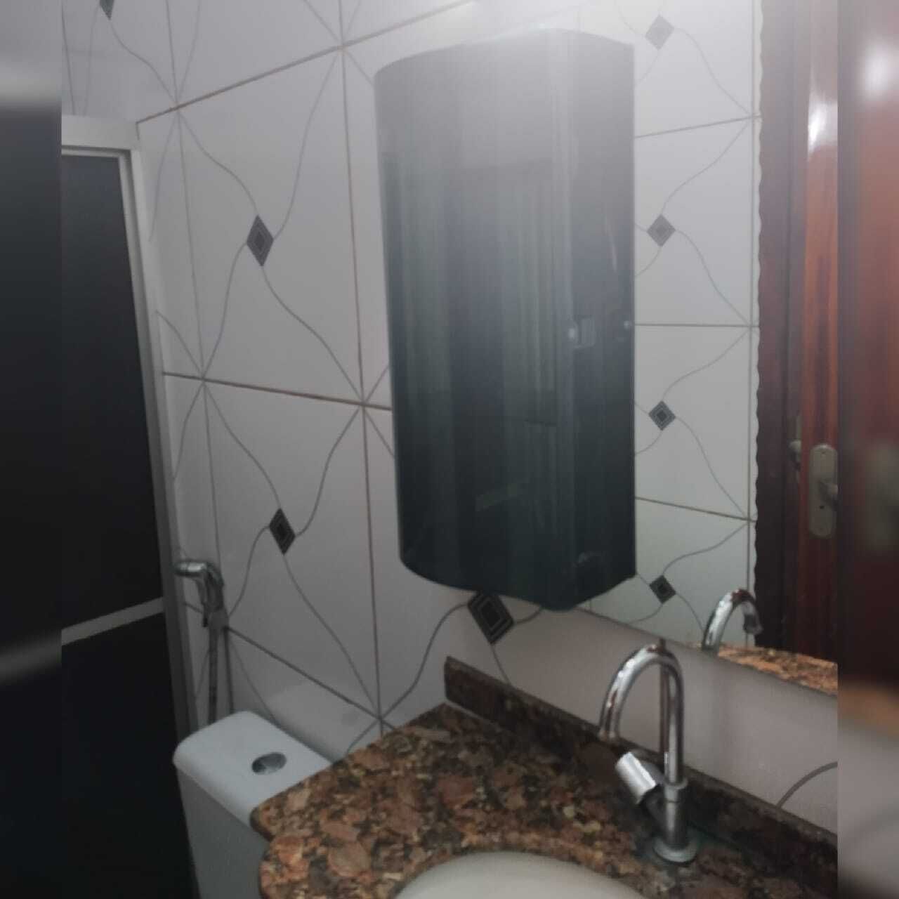 A bathroom with a sink, mirror, and toilet.