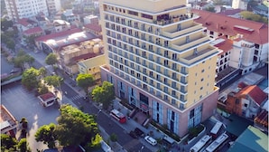 A multi-story hotel with a central courtyard, surrounded by other buildings. - AD 41 Hotel (Hue)