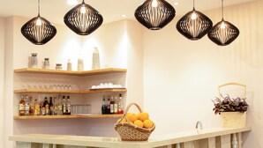 A bar area with a counter, shelves with bottles, and hanging lights. - Dai Nam Sai Gon Hotel (Ho Chi Minh City)