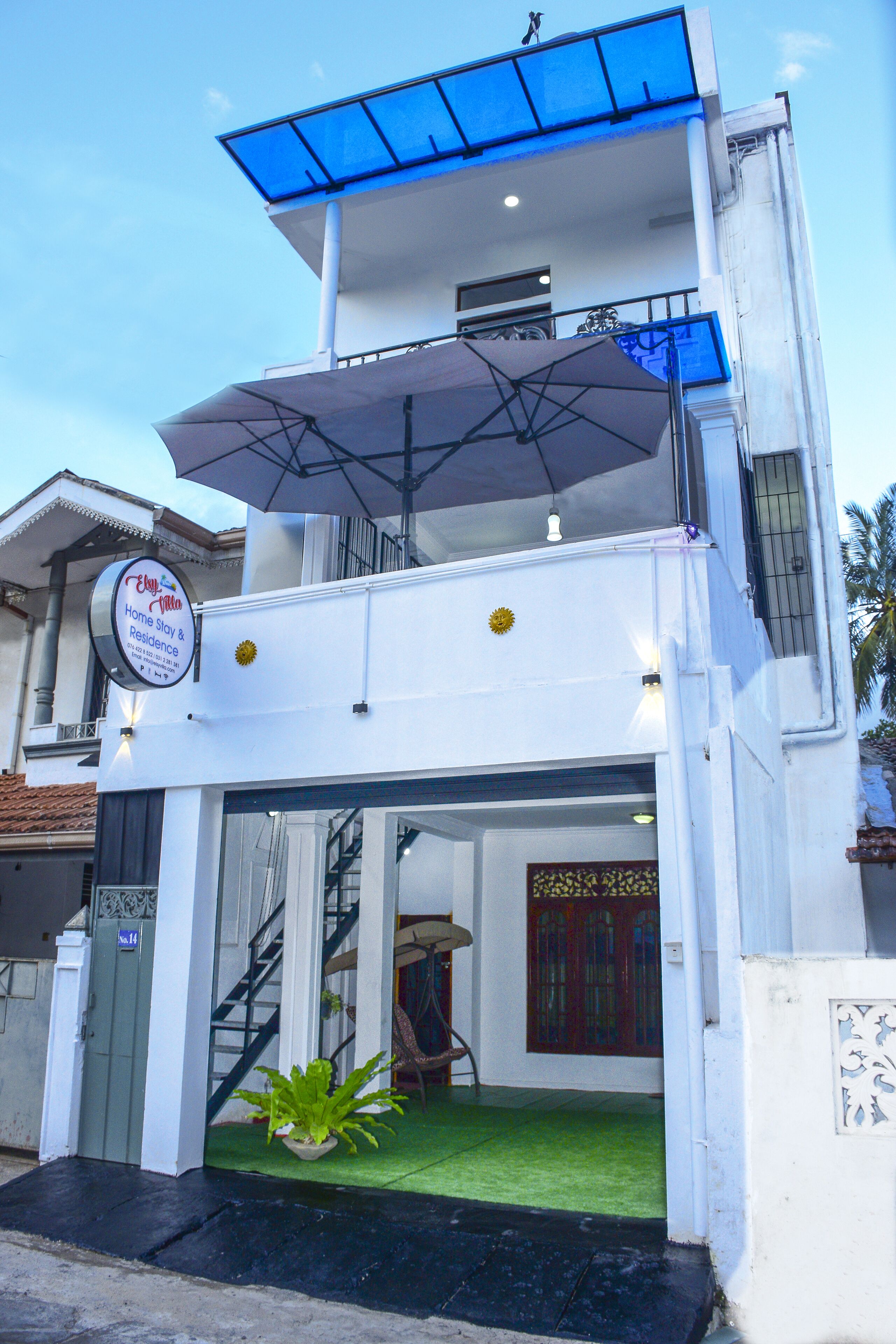 A two-story building with a sign indicating it is a home stay and residence.