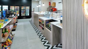 A modern retail space with refrigerated beverage displays, a variety of packaged goods, and a checkout counter. - Steps from clubhouse.  "Be Our Guest" in Windsor Hills-pool heat included (Kissimmee)