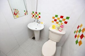 A small bathroom with a sink, toilet, and colorful tiles. - Brothers Pension (Sokcho)