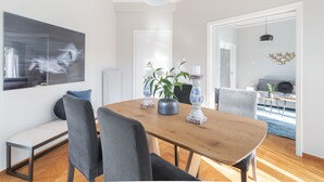 Ett modernt matområde med ett träbord, stolar och dekorativa vaser.