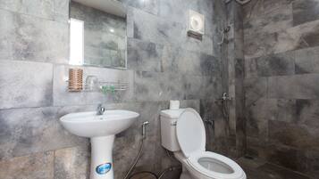 A bathroom with a sink, toilet, and shower.