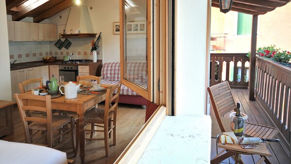 A cozy kitchen with wooden cabinets and a dining area with a table and chairs.