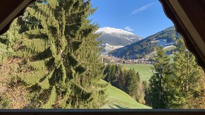 A view from a window overlooking a town with a snow-capped mountain in the background. - Apartment HaNiLe with "honeymoon suite" with dream view - max. 14 pers (Sarnthein)