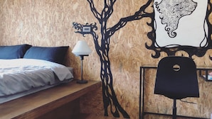 A bedroom with a bed, a desk, and a chair. - Shadow House (Tainan)