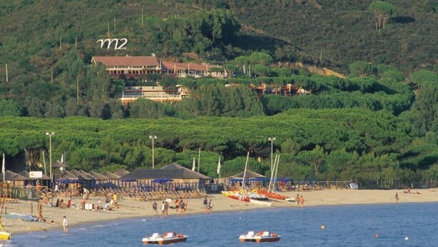 A coastal area with a beach, boats, and a building labeled 'm2' on a hill.