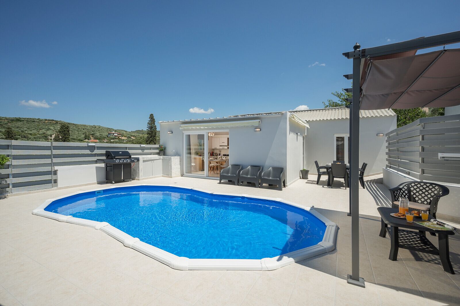 Una piscina al aire libre, sombrillas, tumbonas