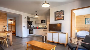 Un apartamento moderno con sala de estar, cocina y un dormitorio.
