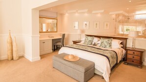 A bedroom with a large bed, bedside tables, a desk, and a mirror. - 18 On Hillwood Villa (Bishopscourt)