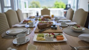 A breakfast table set with plates, cups, and a variety of food items. - 18 On Hillwood Villa (Bishopscourt)