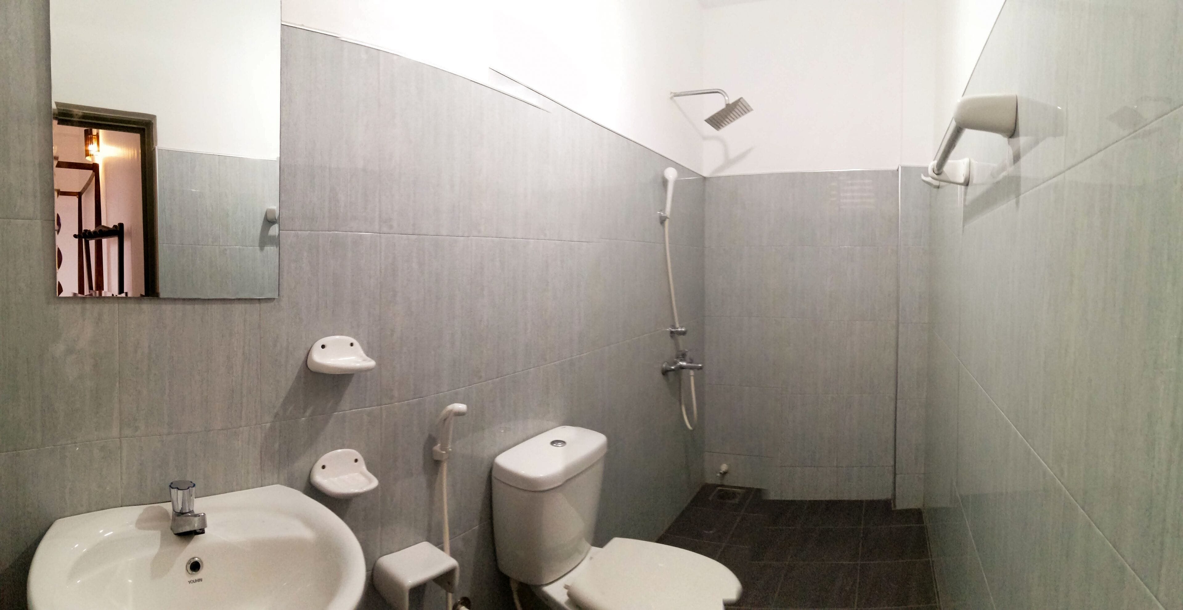 A modern bathroom with a sink, toilet, and shower.