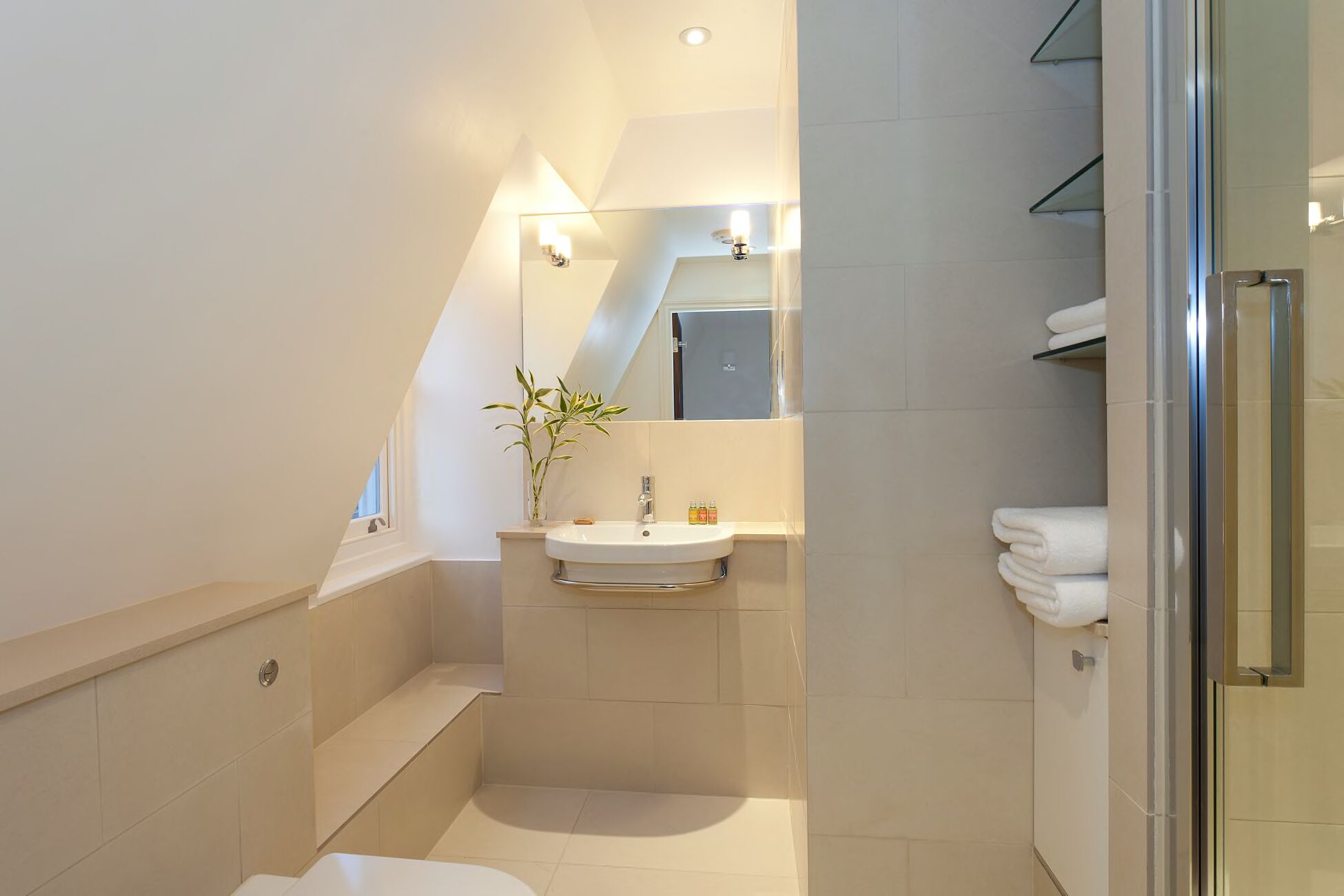 A modern bathroom with a bathtub, a sink, and a shower area.