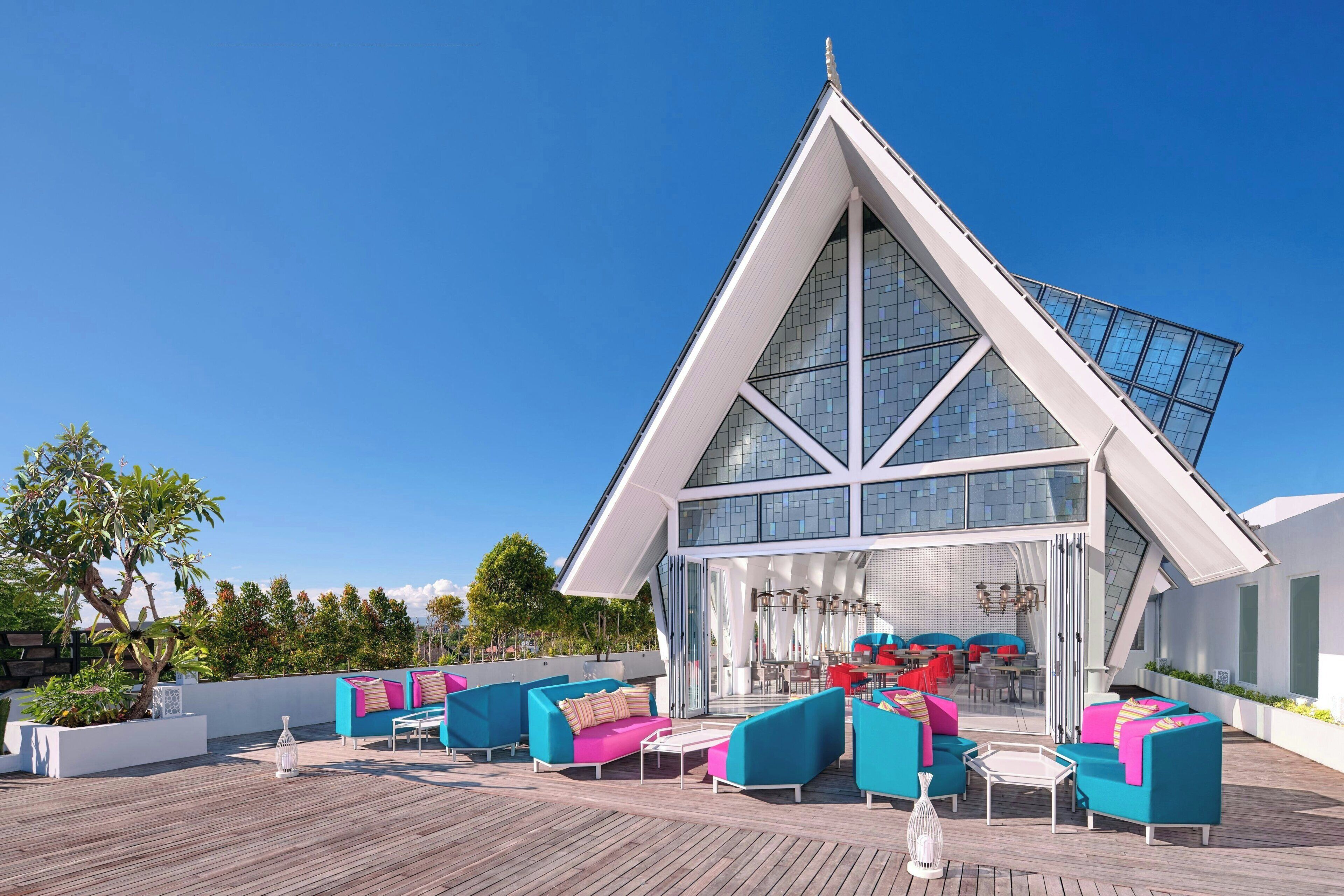 A modern building with a triangular roof and large windows.