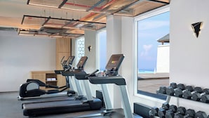 A gym with treadmills, ellipticals, and a rack of dumbbells. - Aloft by Marriott Bali Seminyak (Keroboken Kelod)