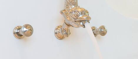 A bathtub with a faucet and a showerhead.