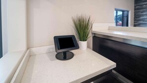 A modern kitchen with a countertop, a tablet, and a potted plant. - Days Inn by Wyndham Galt/Elk Grove South (Galt)