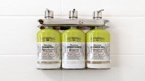 Three J.R. Watkins products: refreshing shampoo, nourishing conditioner, and shower gel, all in green and white bottles. - Holiday Inn Express & Suites Marion by IHG (Marion)