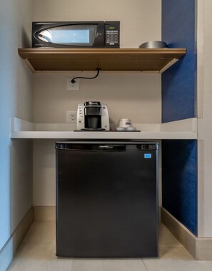 A compact kitchenette with a microwave, coffee maker, and refrigerator. - Holiday Inn Express & Suites Marion by IHG (Marion)