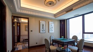 A spacious room with a wooden floor, a billiards table, and a view of the city through large windows. - Wyndham Zhuji West (Shaoxing)