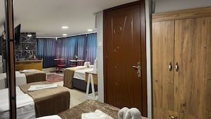 A hotel room with a bed, a desk, a wardrobe, and a dining area with a table and chairs. - Galaxy Hotel Sultanahmet (Istanbul)