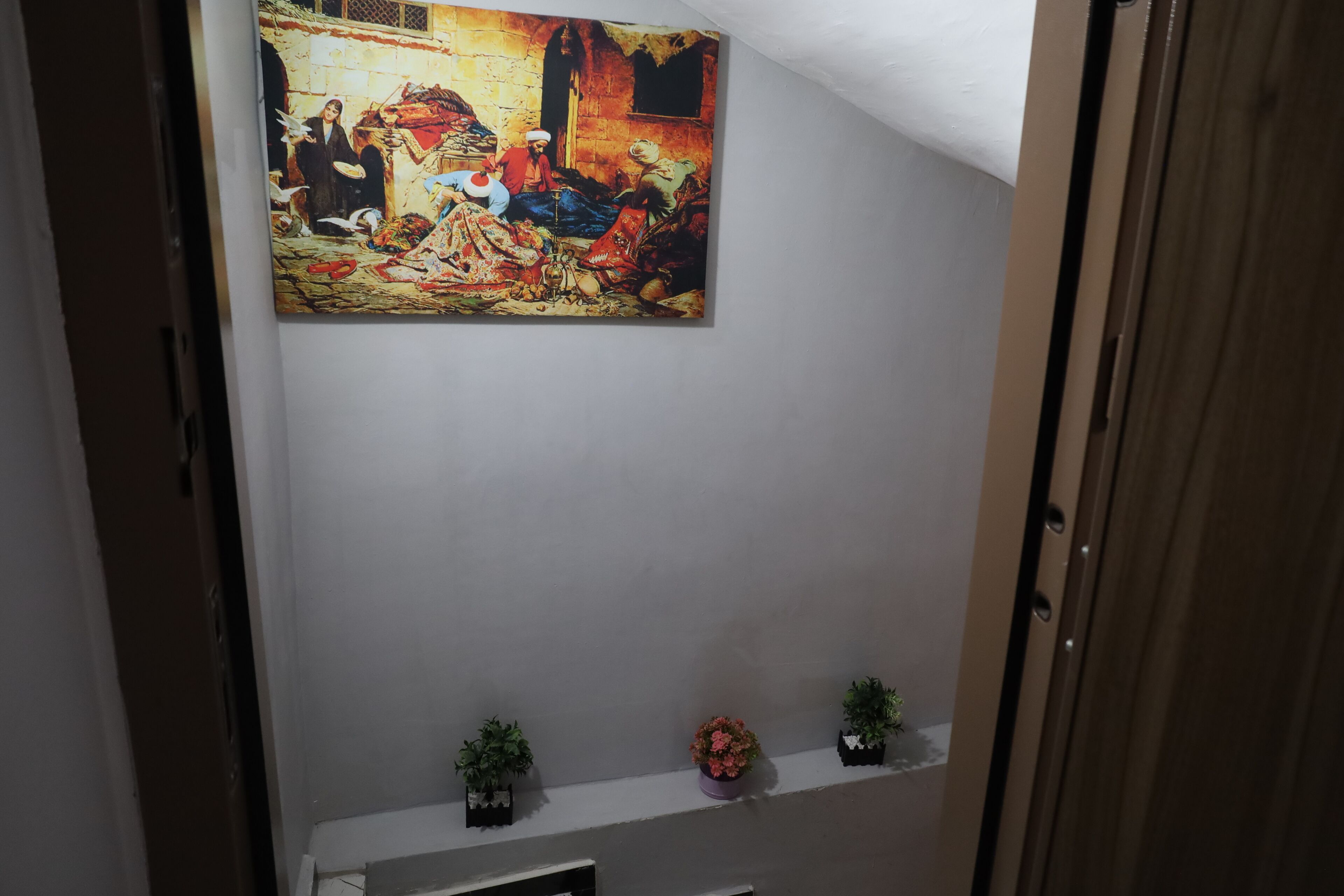 A painting of a historical scene on a wall.