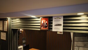 A reception desk with a computer, a red chair, and a SIM card display. - Galaxy Hotel Sultanahmet (Istanbul)