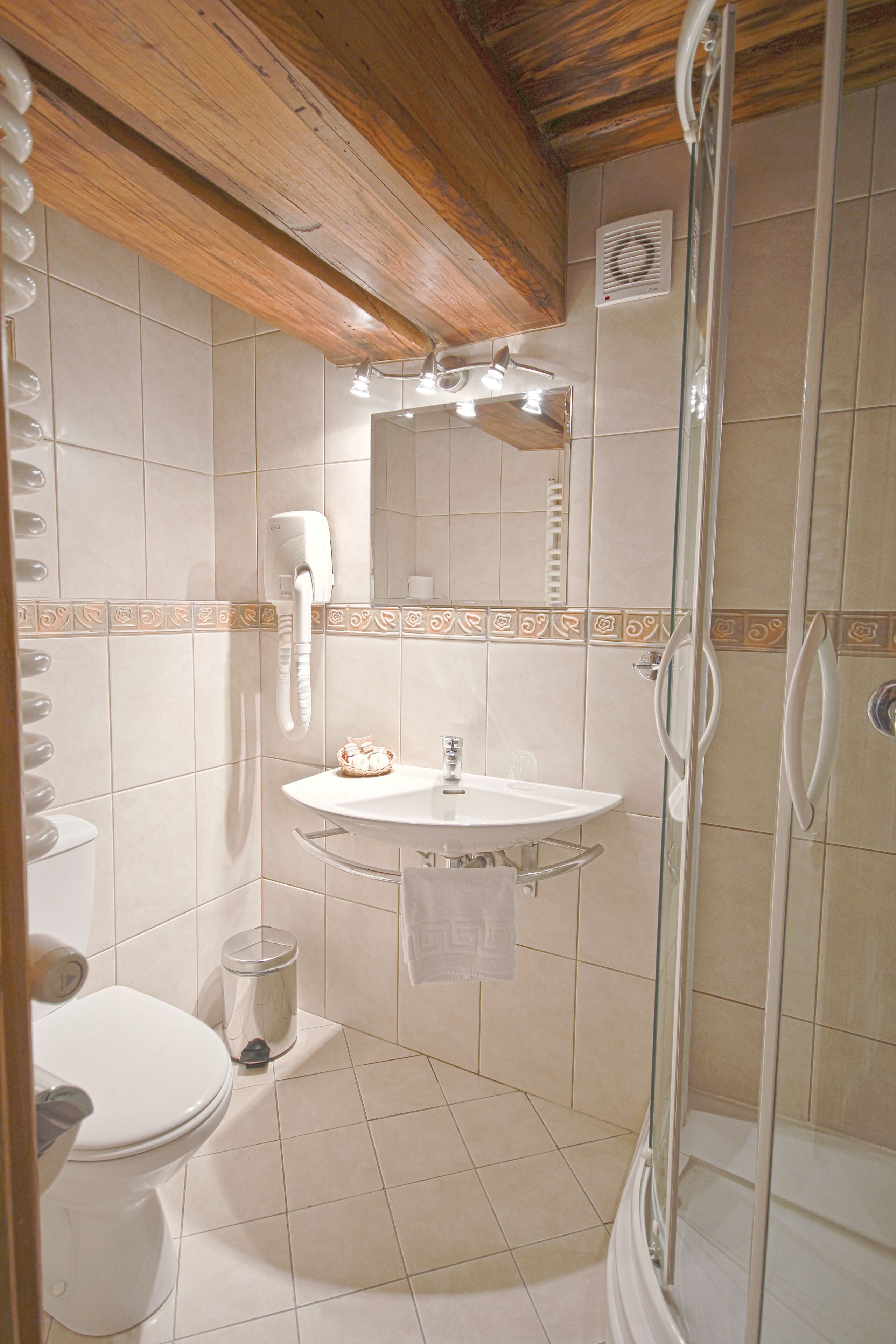 A bathroom with a toilet, sink, and shower.