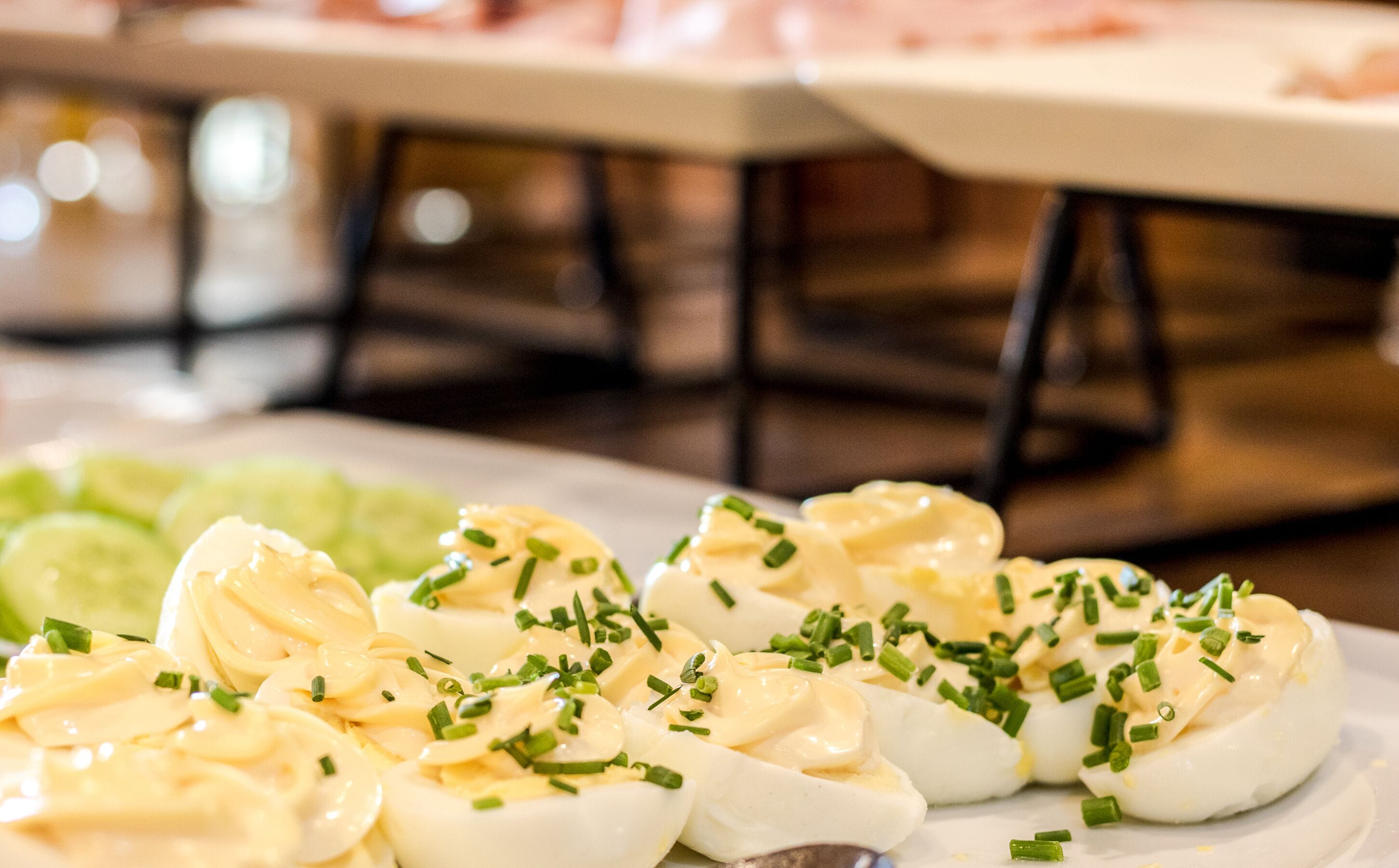 A plate of deviled eggs garnished with chives.
