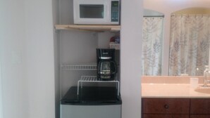 A compact kitchenette with a microwave, coffee maker, and a small refrigerator. - CLEAN, COMFORTABLE, FULLY PRIVATE UNIT IN GATED COMMUNITY  (Ocala)