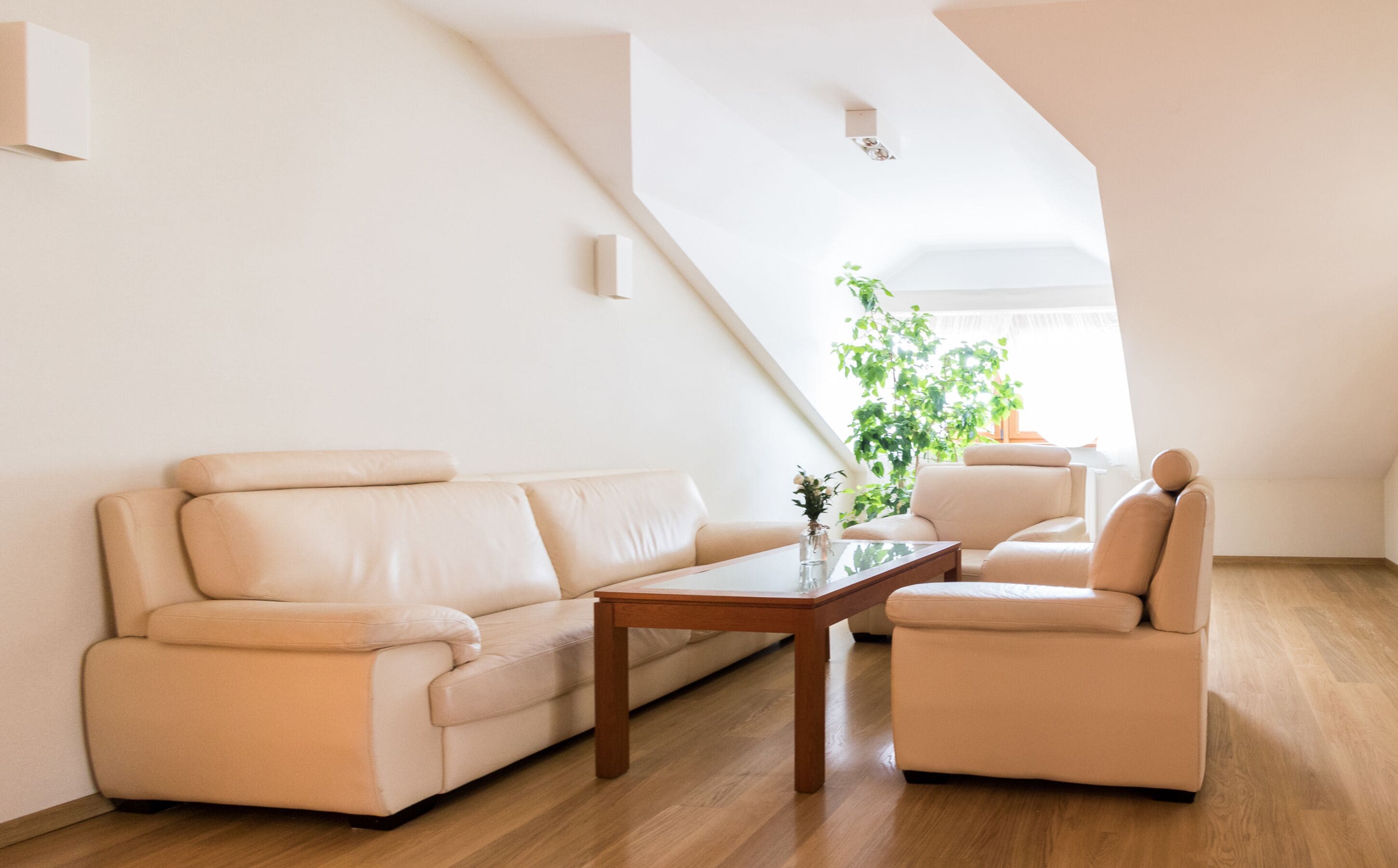 A modern living room with a sofa, armchair, and coffee table.