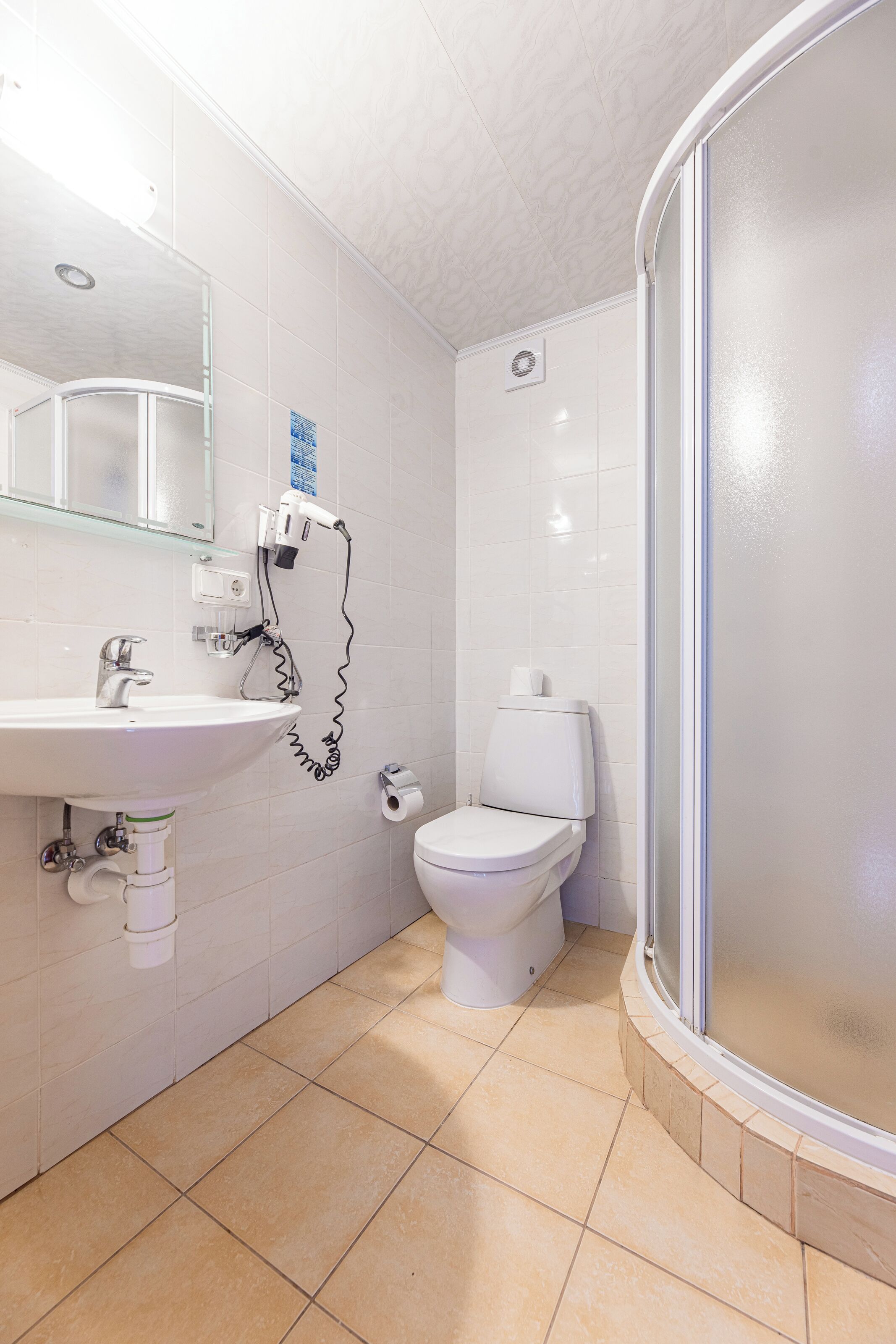 A bathroom with a sink, toilet, and shower.