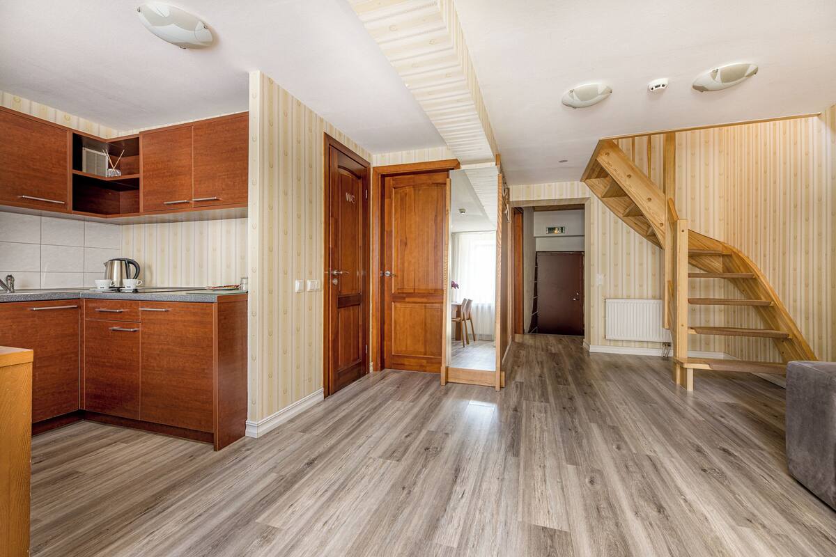 A spacious kitchen with wooden cabinets and a modern design.